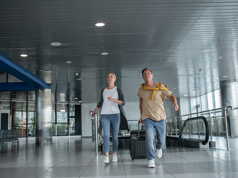 Illustration of a traveler checking in luggage at the airport